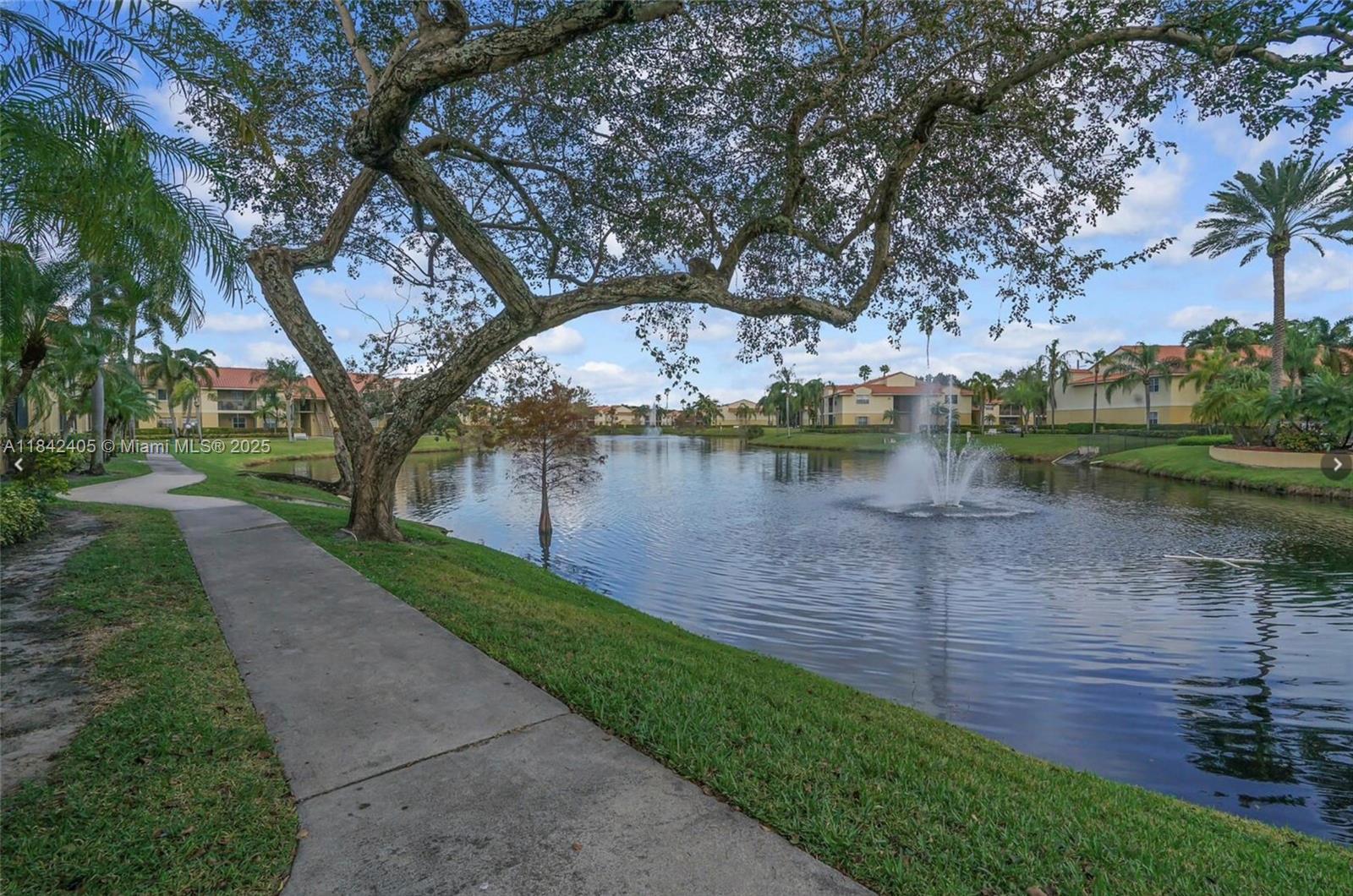 1227 Southwest 46th Avenue, Unit 314 Pompano Beach, FL 33069 - Photo 26 of 36 a view of a lake with houses in back