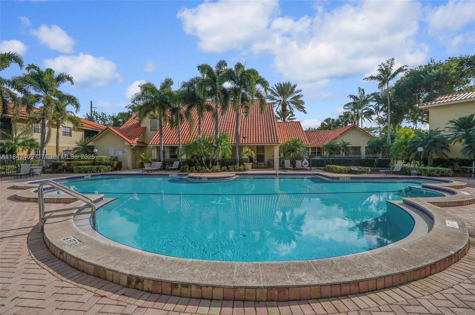 1227 Southwest 46th Avenue, Unit 314 Pompano Beach, FL 33069 - Photo 4 of 36 a view of a swimming pool with a sitting space