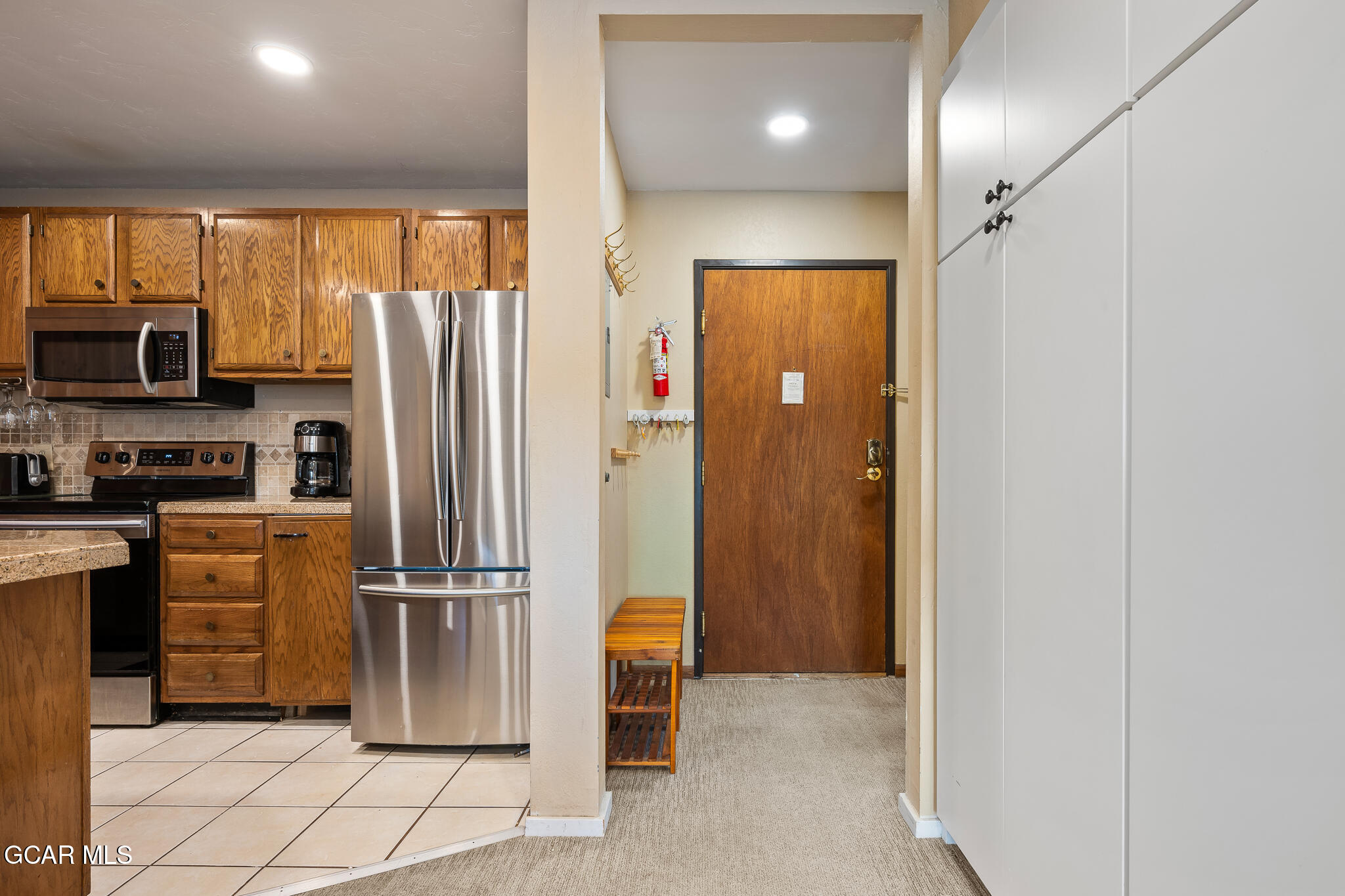 490 Kings Crossing Road, Unit 611 Winter Park, CO 80482 - Photo 17 of 39 a kitchen with stainless steel appliances a refrigerator and a stove top oven
