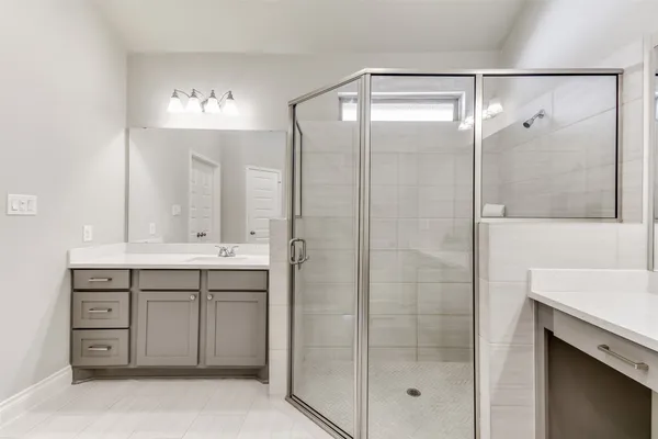 a bathroom with a shower sink and mirror