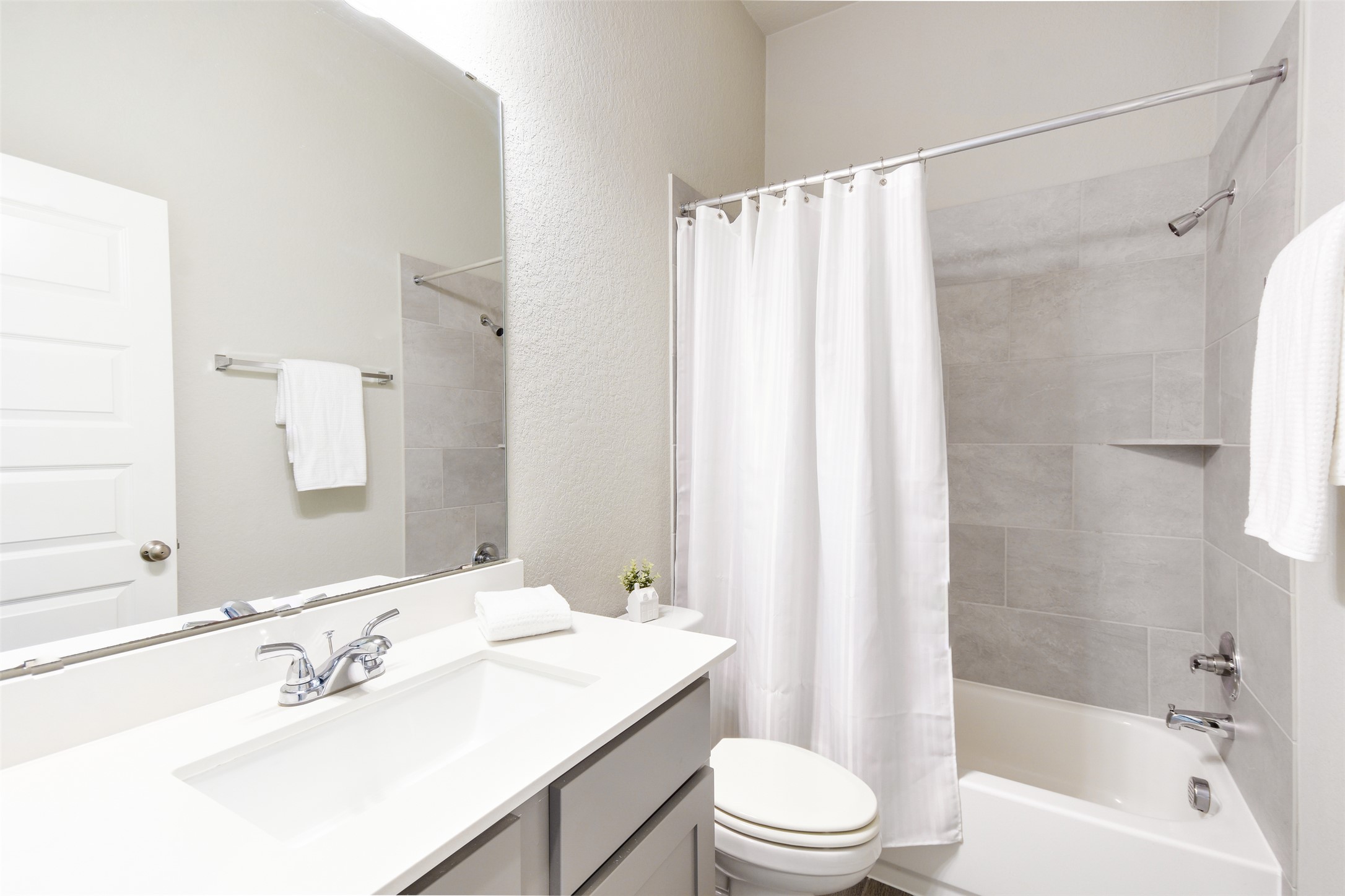 228 Pisa Lane Georgetown, TX 78628 - Photo 15 of 28 a bathroom with a sink a toilet and a large mirror