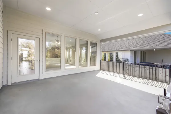 a view of an empty room and floor to ceiling window and wooden floor