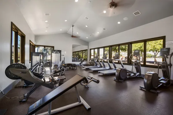 a room with gym equipment and a large window