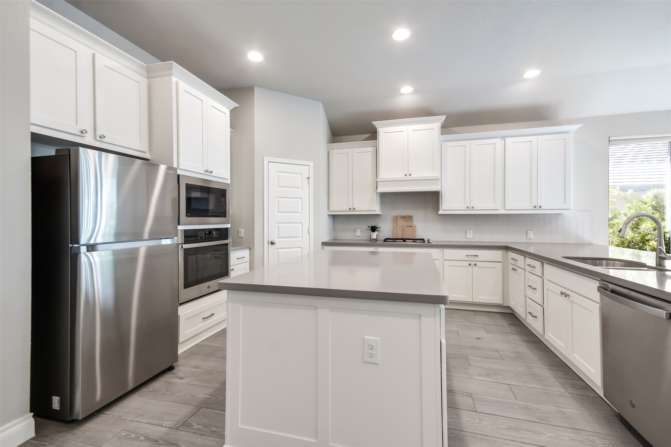 228 Pisa Lane Georgetown, TX 78628 - Photo 4 of 28 a kitchen with stainless steel appliances cabinets a sink and a refrigerator