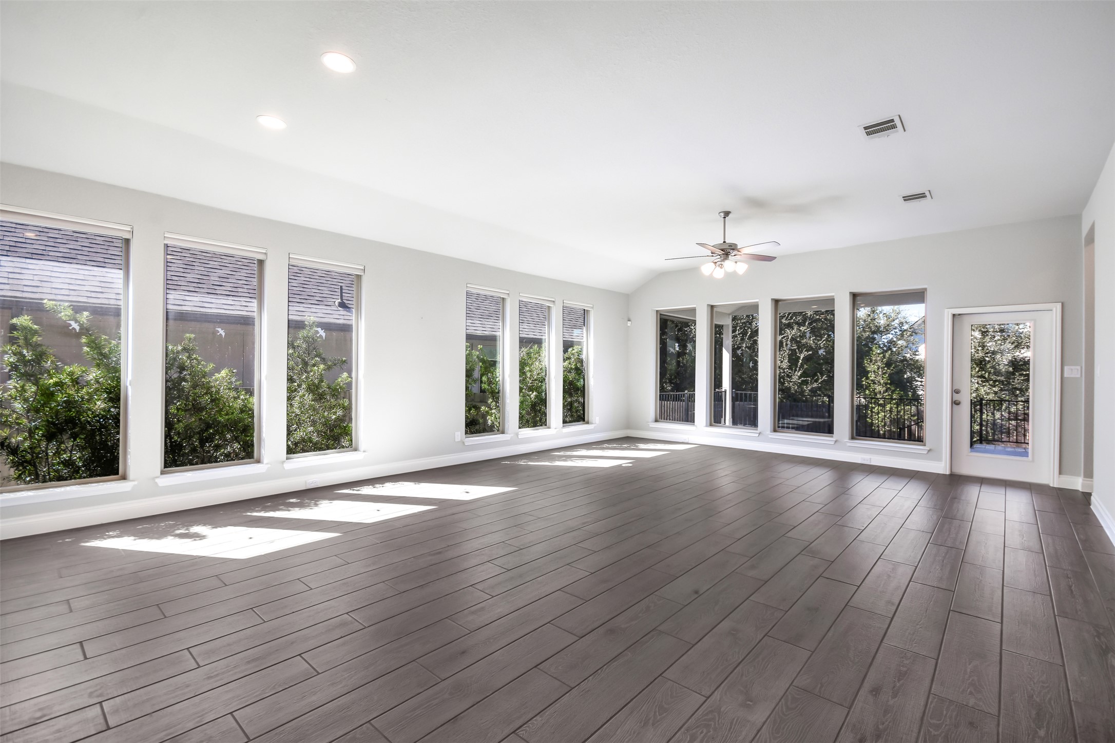 228 Pisa Lane Georgetown, TX 78628 - Photo 6 of 28 a view of an empty room with wooden floor and a window