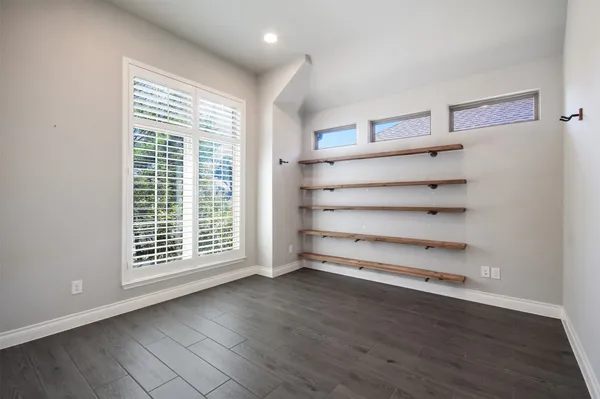 a view of room with wooden floor and windows
