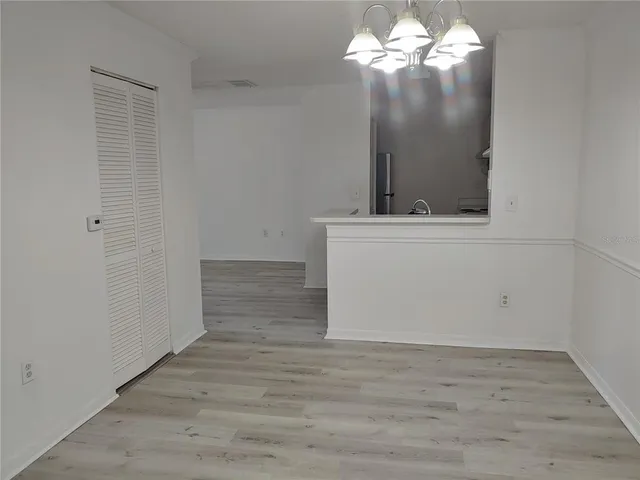 a view of a chandelier fan and wooden floor