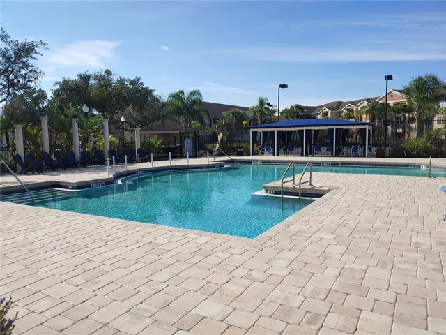 a view of a house with a yard and potted plants