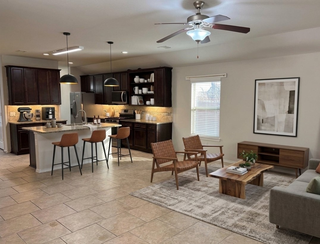 24307 Hampton Terrace Lane Spring, TX 77389 - Photo 5 of 20 Experience the perfect blend of comfort and style in this virtually staged open-concept living area, featuring a modern kitchen, cozy breakfast Bar, and inviting living room.