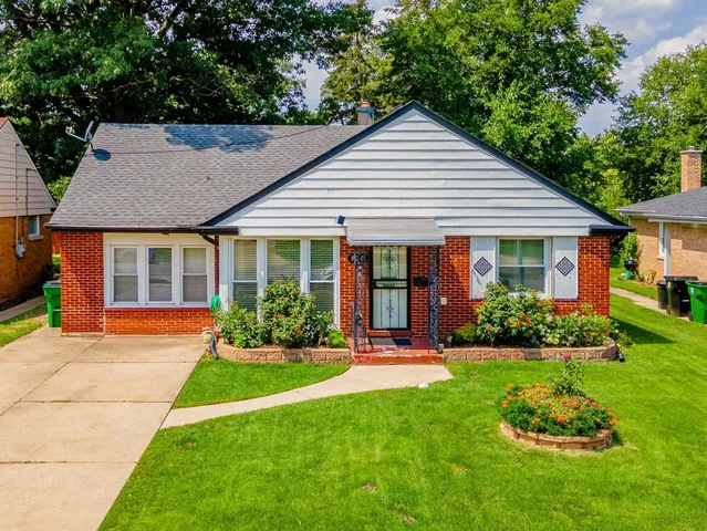 a front view of a house with a yard table and chairs