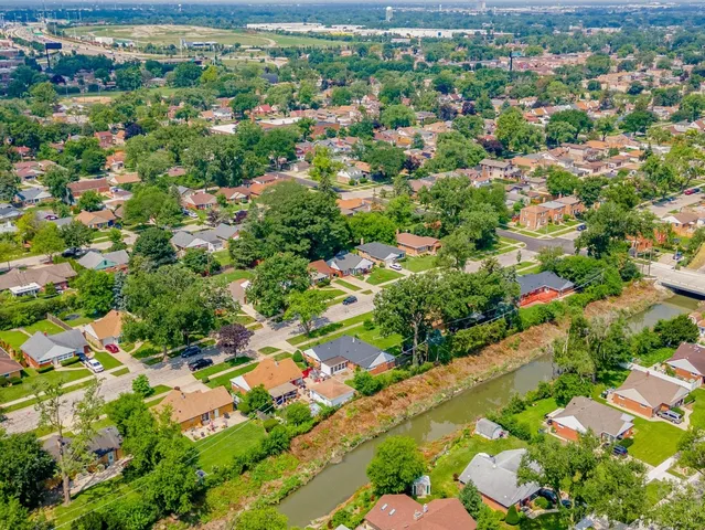 an aerial view of residential houses with outdoor space