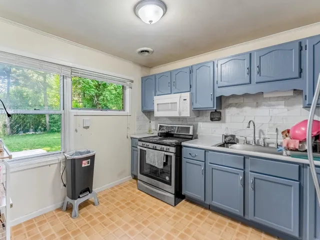 a kitchen with a sink cabinets and window