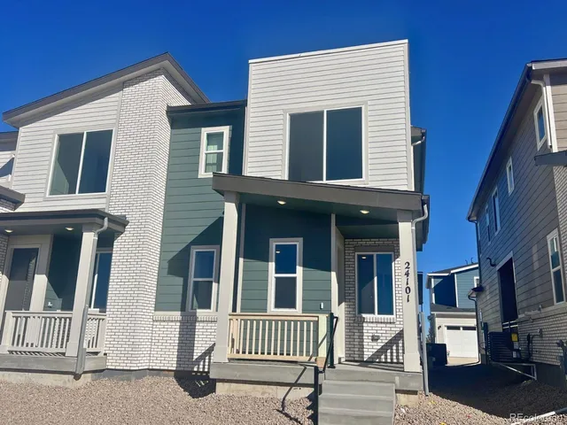 a view of a brick house with many windows
