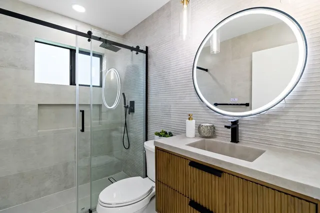 a bathroom with a toilet sink and mirror