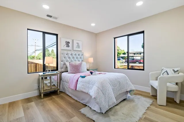 a view of a patio with table and chairs with wooden fence and plants