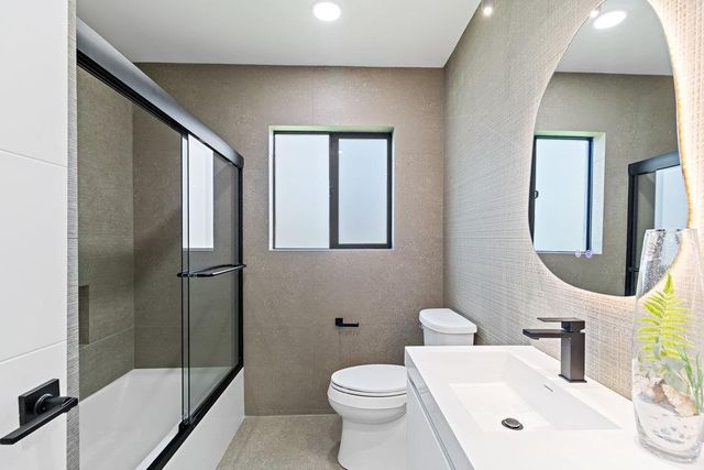 a view of a white house with a big yard and palm trees