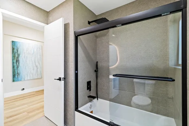 a white house with a small yard and wooden fence