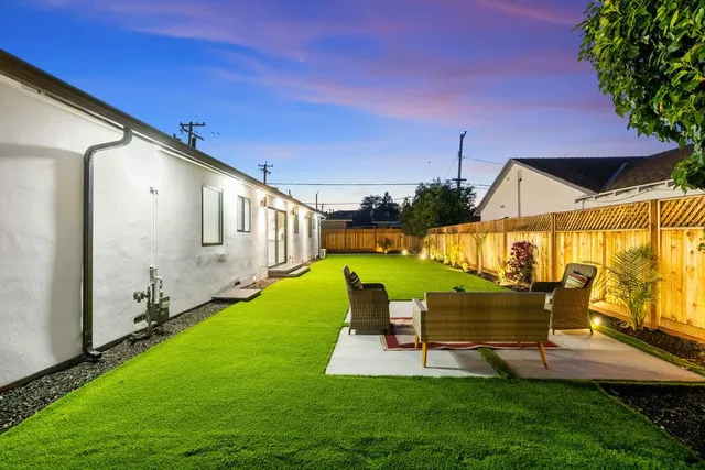 a backyard of a house with lots of green space and lake view