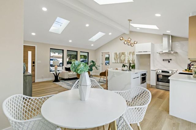 a living room with kitchen island furniture and a view of kitchen