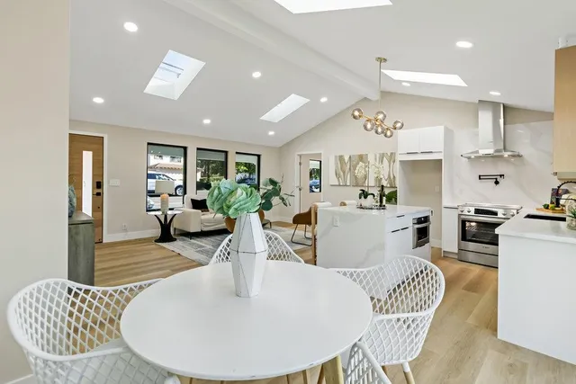 a living room with kitchen island furniture and a view of kitchen