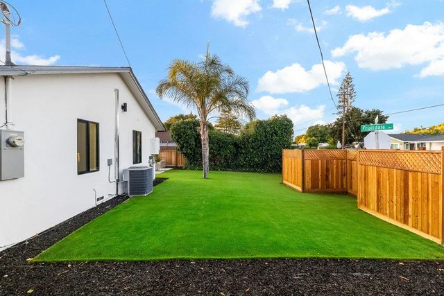 a dining room with wooden floor a chandelier a wooden table and chairs