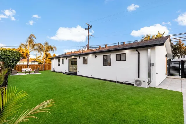 a view of a hallway with wooden floor and closet area