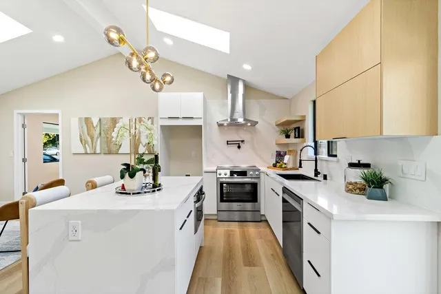 a kitchen with a sink cabinets and a large window