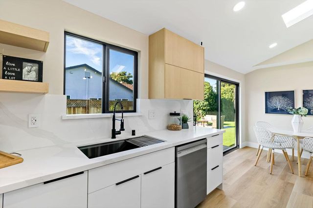 a living room with furniture and kitchen view