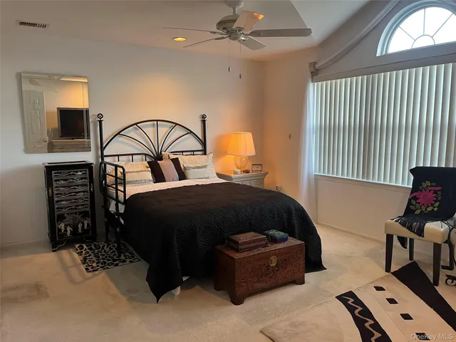 a bedroom with a bed and a mirror