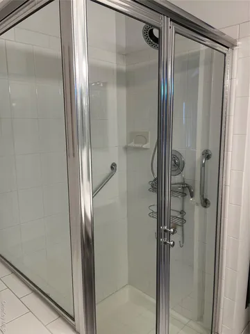 a bathroom with a glass shower door