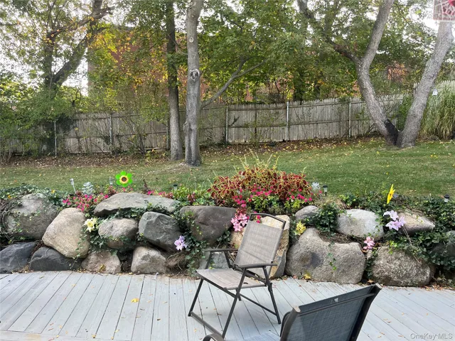 a view of a wooden bench and some potted plants