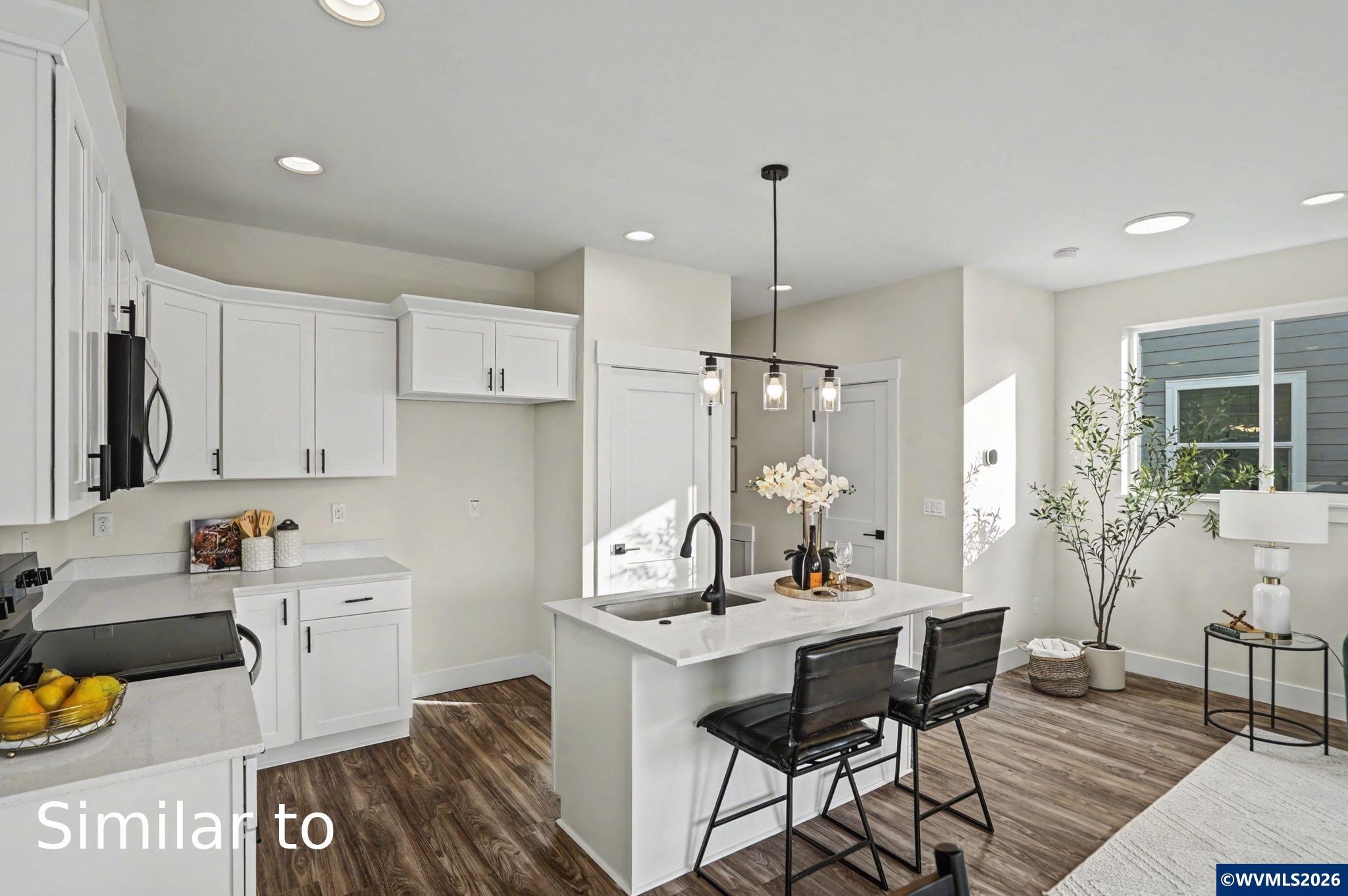 2550 Promise Way Lebanon, OR 97355 - Photo 10 of 35 a view of a kitchen with kitchen island dining table and chairs