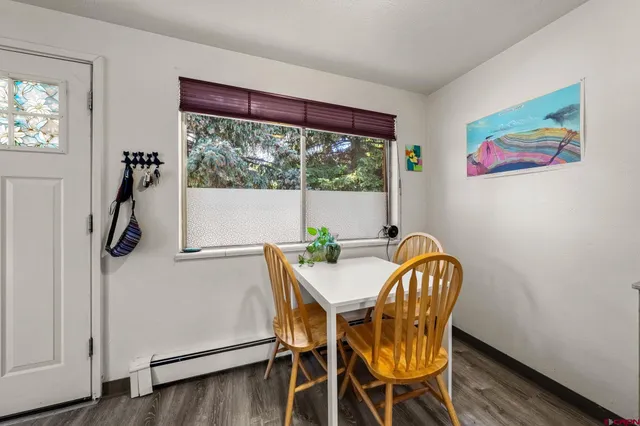 a view of a dining room with furniture window and wooden floor