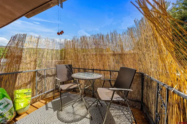 a view of a chairs and table in patio