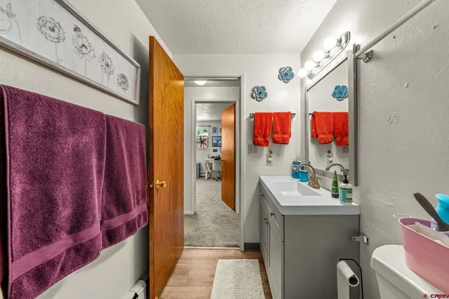 a bathroom with a sink and mirror with toilet