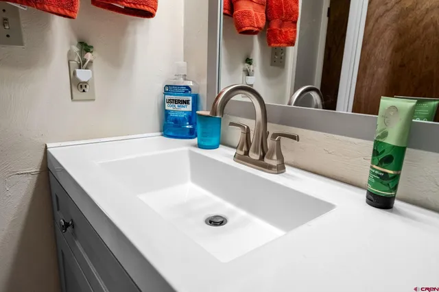 a bathroom with a sink and a mirror