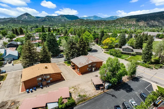 an aerial view of residential houses with outdoor space and street view
