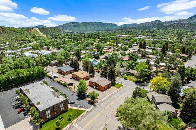 an aerial view of a residential apartment building with a yard