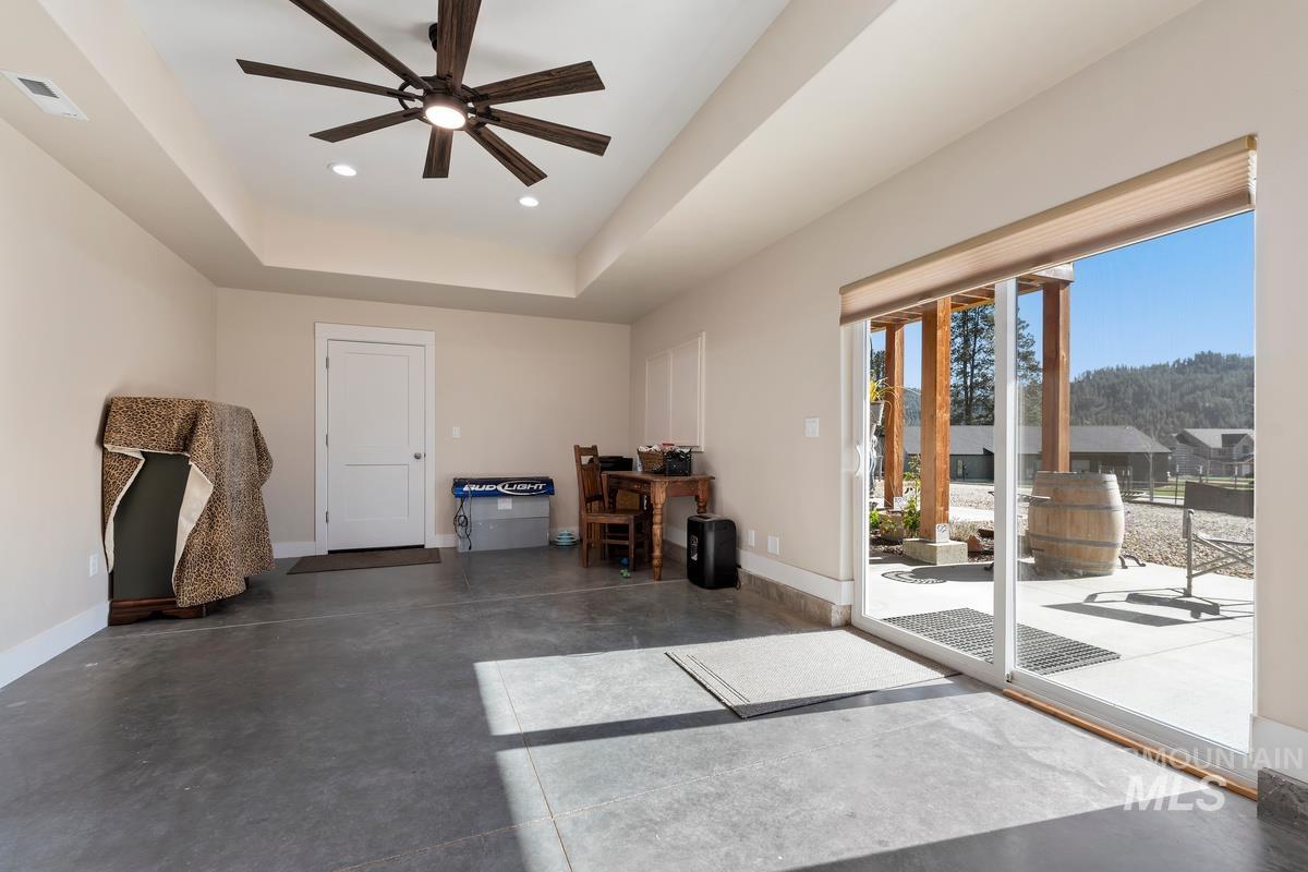 21 Open Road Garden Valley, ID 83622 - Photo 31 of 49 Interior space featuring concrete flooring, a tray ceiling, a ceiling fan, and recessed lighting