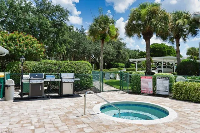 a view of a patio with table and chairs potted plants and palm trees