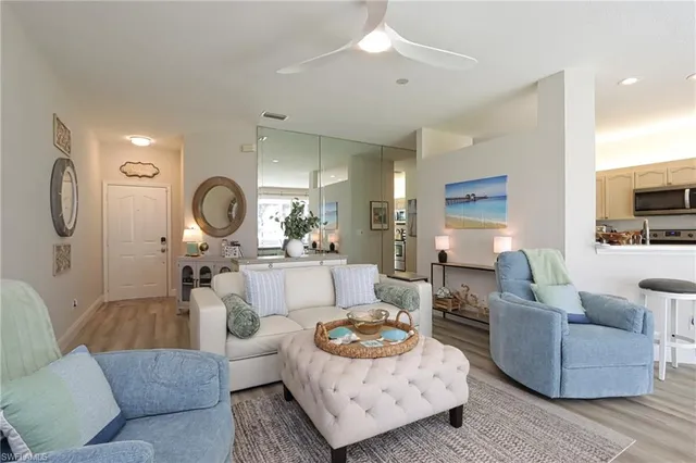 a living room with furniture and a large mirror