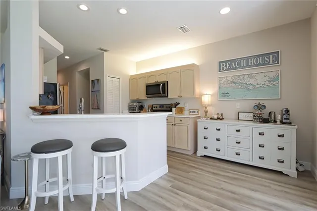a kitchen with granite countertop a sink cabinets and stainless steel appliances