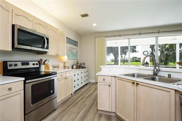 a kitchen with stainless steel appliances granite countertop a sink and a stove top oven