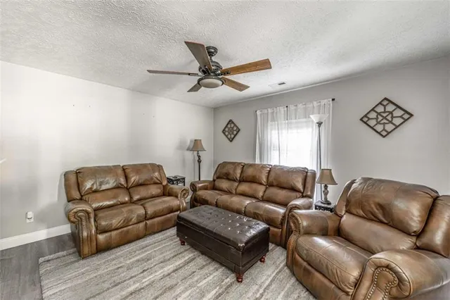 a kitchen with granite countertop a stove a sink and a microwave