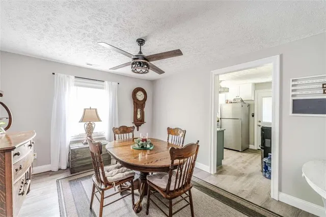 a view of a dining room with furniture and a potted plant