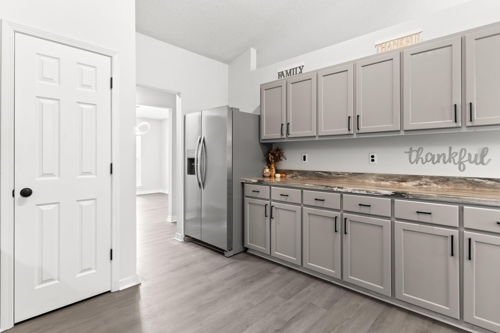 3650 Berrypatch Lane Pace, FL 32571 - Photo 11 of 53 a kitchen with cabinets and a refrigerator