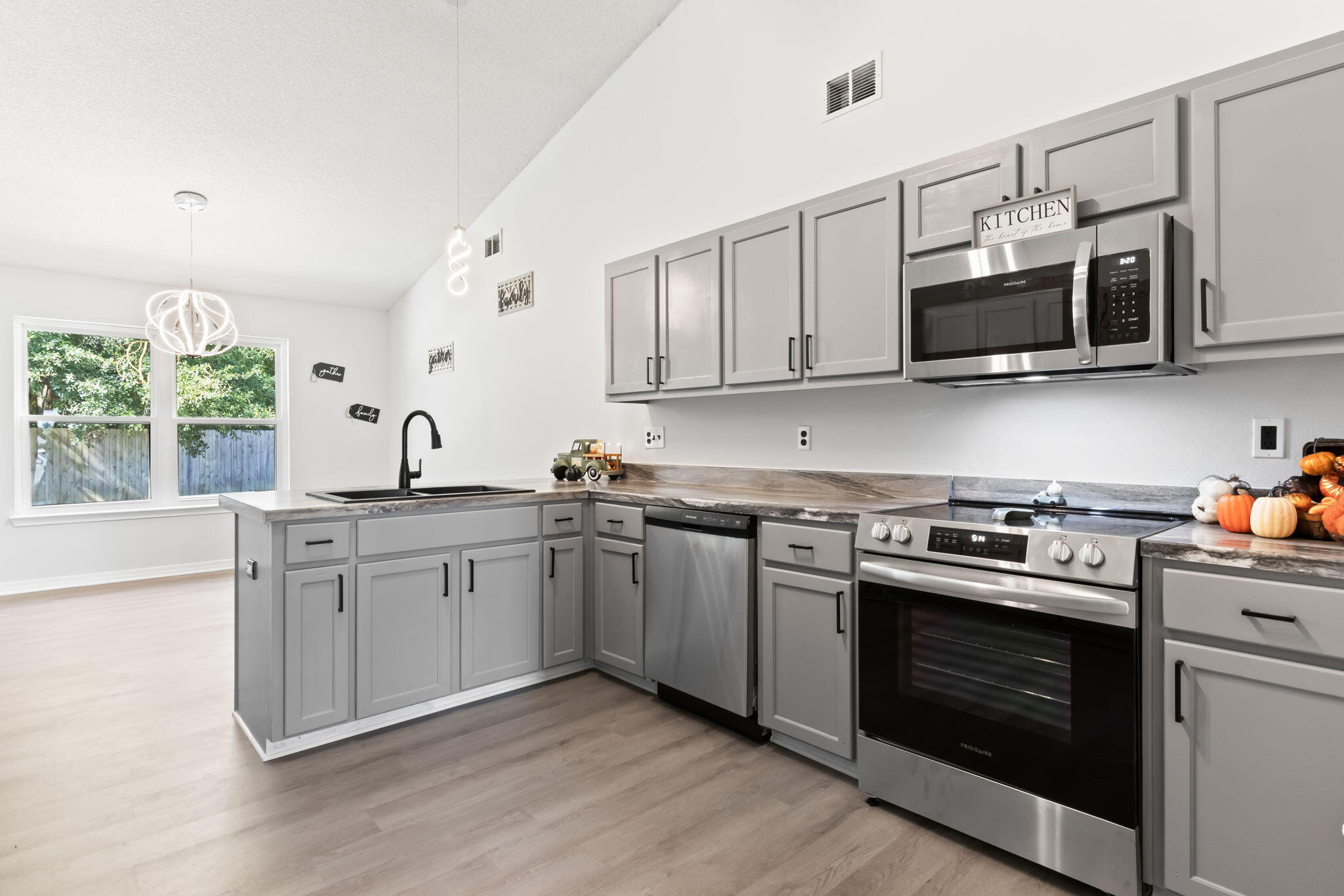 3650 Berrypatch Lane Pace, FL 32571 - Photo 13 of 53 a kitchen with stainless steel appliances granite countertop a sink dishwasher a stove and a microwave oven with cabinets