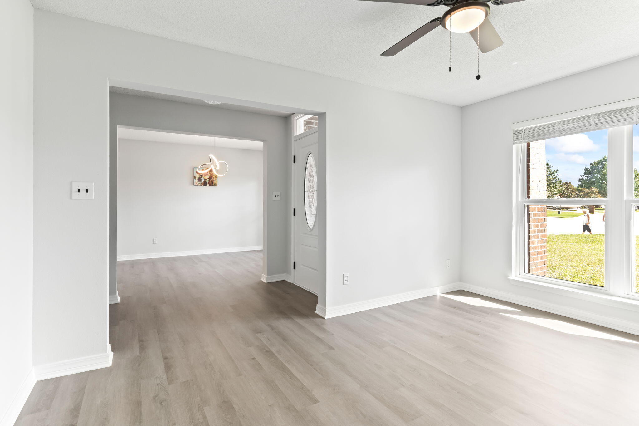 3650 Berrypatch Lane Pace, FL 32571 - Photo 15 of 53 a view of an empty room with wooden floor and a window