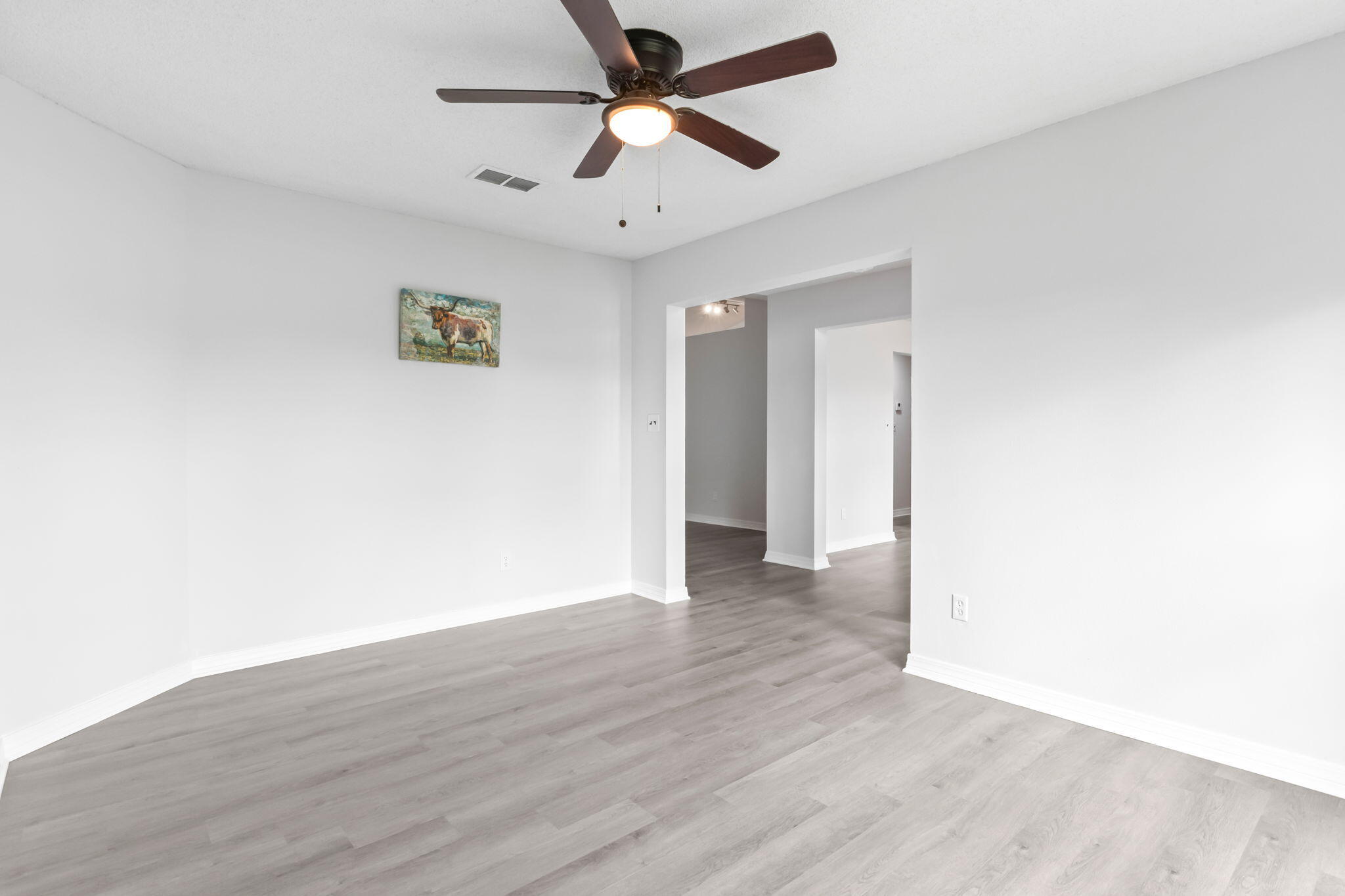3650 Berrypatch Lane Pace, FL 32571 - Photo 16 of 53 a view of a big room with wooden floor and a ceiling fan