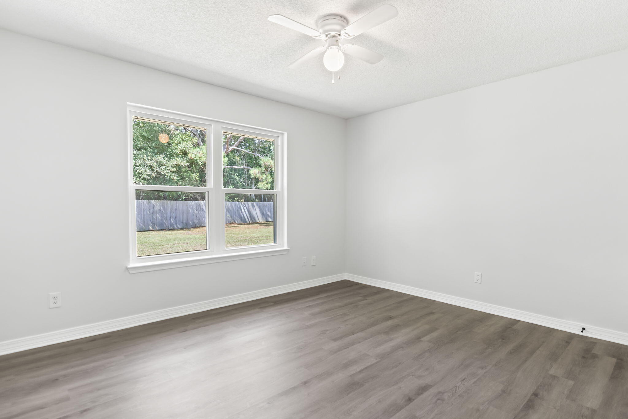 3650 Berrypatch Lane Pace, FL 32571 - Photo 31 of 53 an empty room with wooden floor and windows